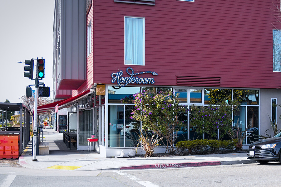 Homeroom’s red Oakland restaurant facade and illuminated Homeroom sign